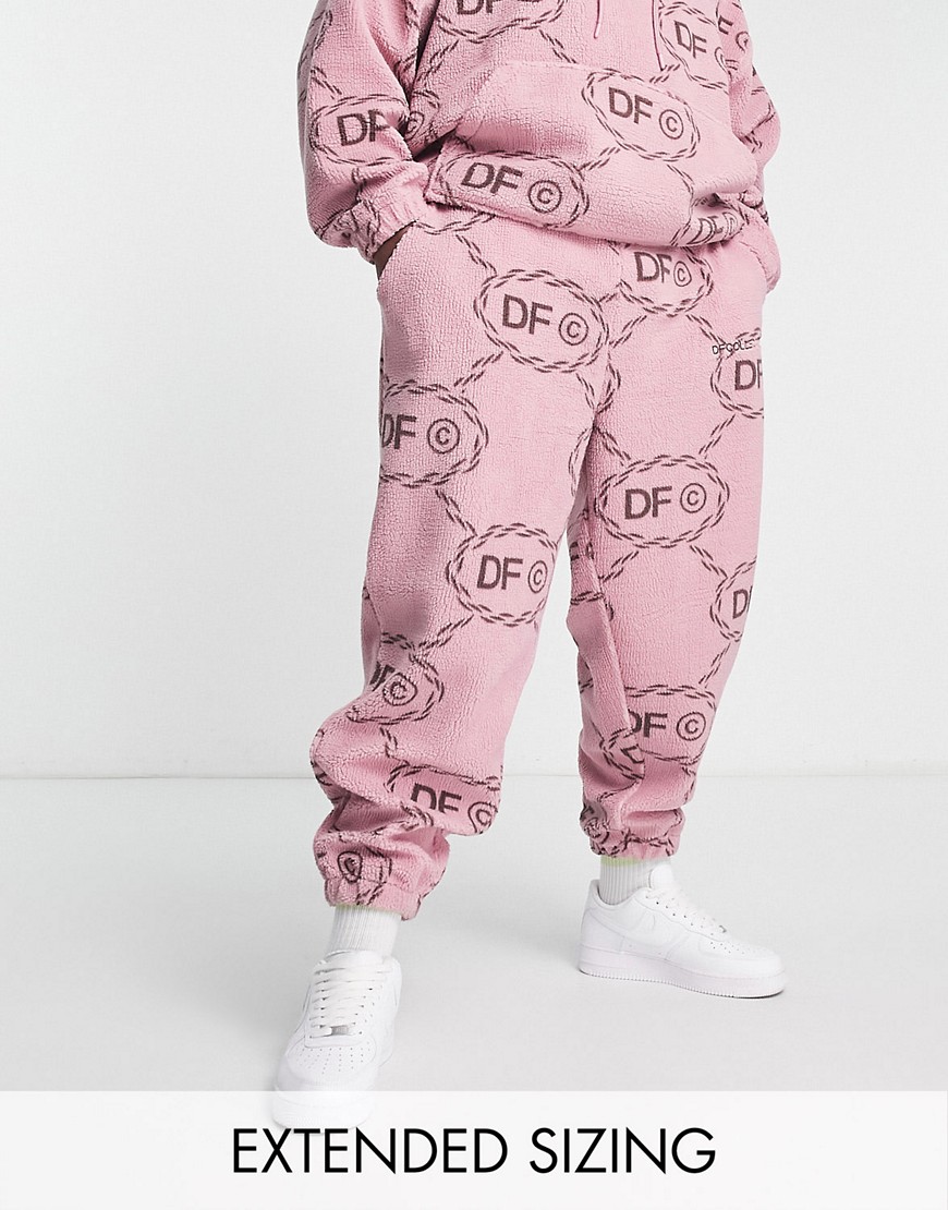 ASOS Dark Future co-ord relaxed joggers in teddy borg with all over monogram logo print and embroidery in pink