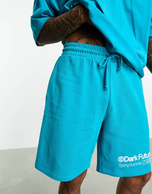 ASOS Dark Future Locker geschnittene Shorts in Blau mit Logoprint am Bein Kombiteil ASOS