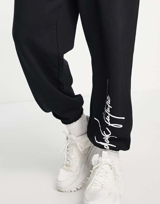 ASOS Dark Future relaxed sweatpants with graffiti logo graphic prints and  fixed hem in white - part of a set