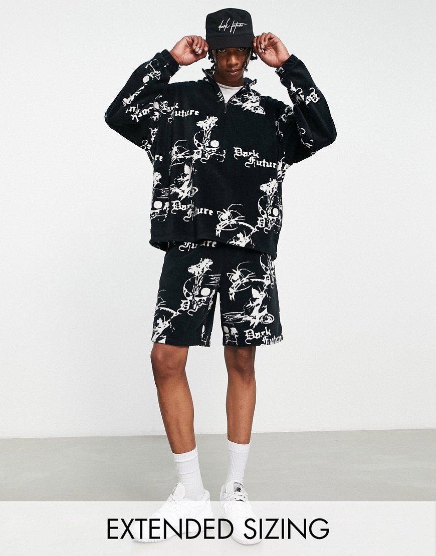 ASOS Dark Future relaxed shorts in polar fleece with all over logo graphic print in black