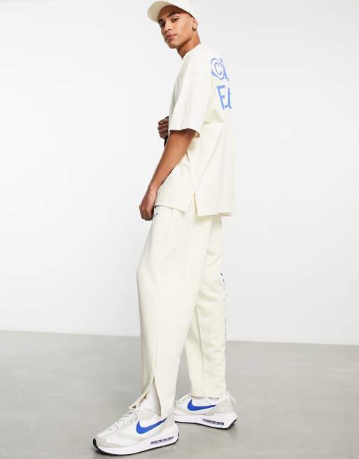 ASOS Dark Future relaxed sweatpants with side slits and logo puff prints in off white part of a set ASOS