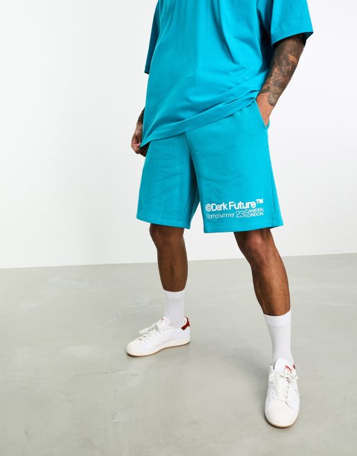 ASOS Dark Future - Ruimvallende co-ord set met short met logoprint op de pijp in blauw