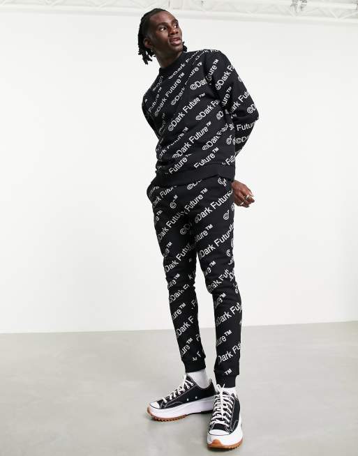 ASOS Dark Future skinny trackies with all over logo print in black (part of a set)