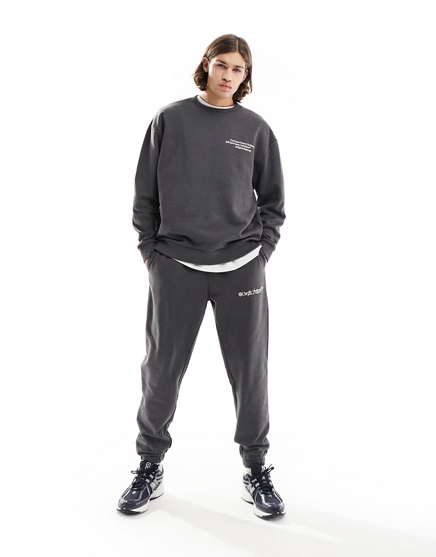 tapered sweatpants in charcoal gray with print