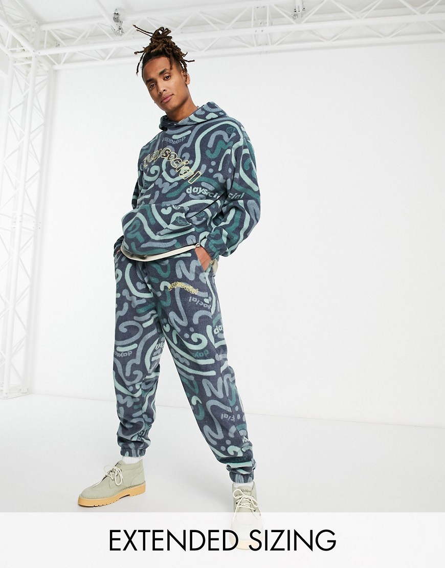 ASOS Daysocial co-ord relaxed joggers in polar fleece with all over doodle print in navy