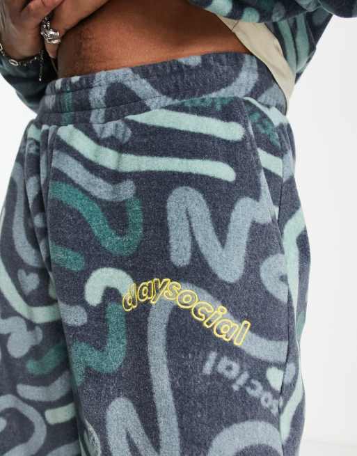 ASOS Daysocial co-ord relaxed joggers in polar fleece with all over doodle  print in navy