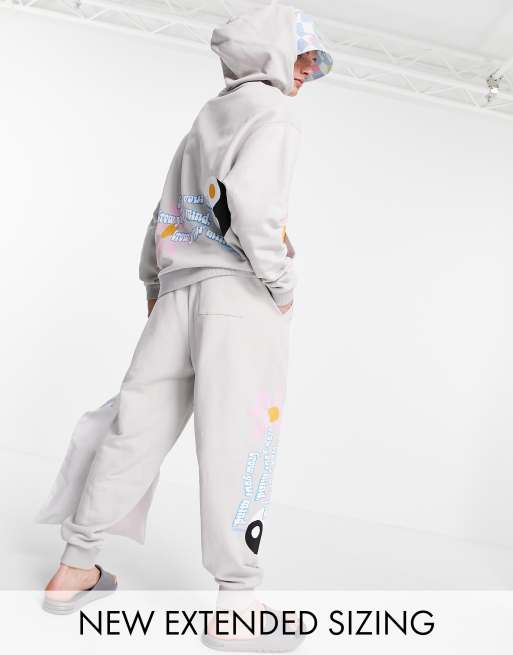 ASOS Daysocial coordinating oversized sweatpants with multi placement logo and graphic prints in stone
