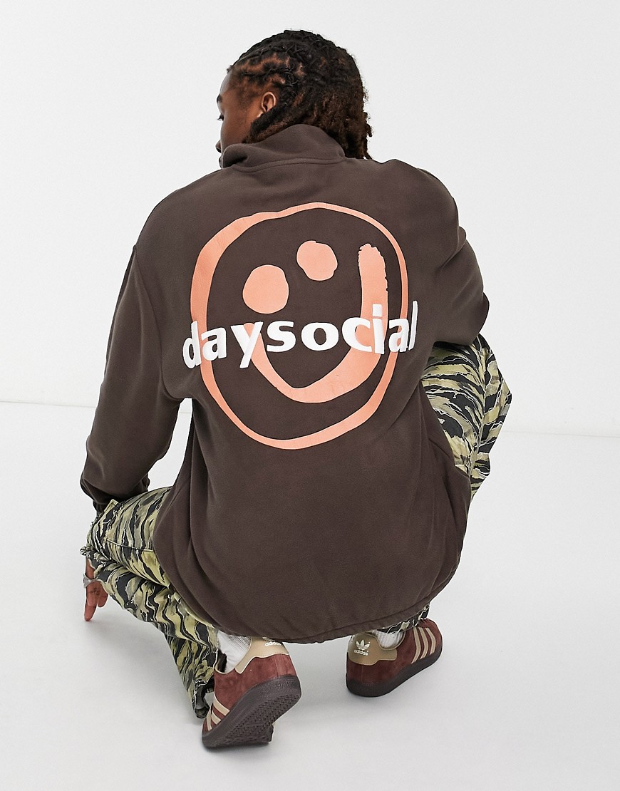 ASOS Daysocial oversized quarter zip sweatshirt in polar fleece with large back smile in brown