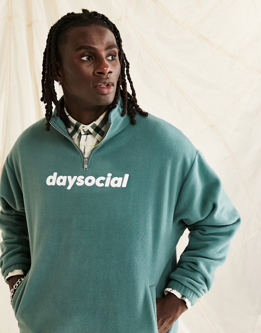 ASOS Daysocial oversized quarter zip sweatshirt in polar fleece with logo print in teal blue
