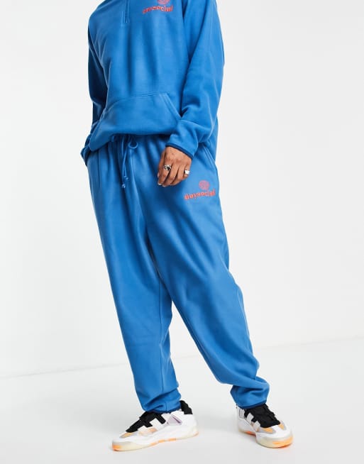ASOS - Daysocial - Ruimvallende joggingbroek van polar fleece met logoprint in blauw, deel van co-ord set