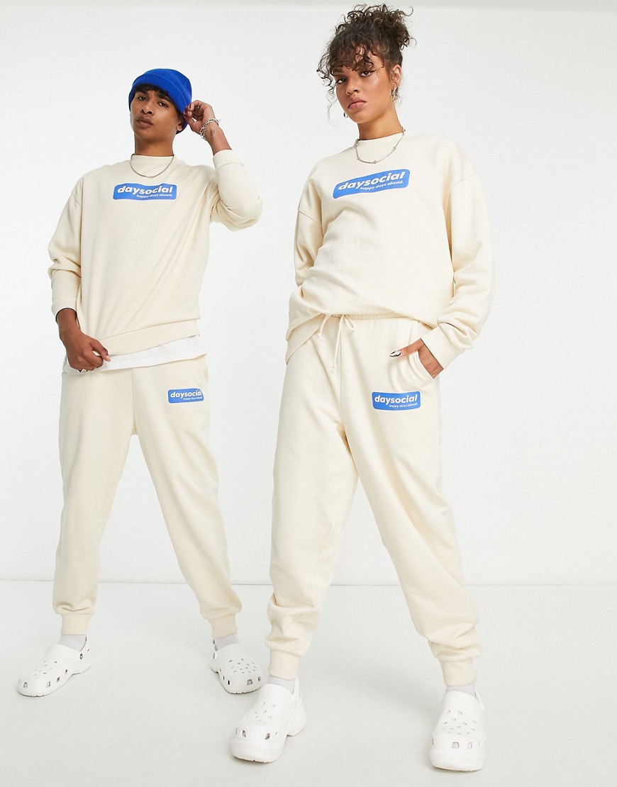 ASOS Daysocial unisex co-ord relaxed joggers with blue badge logo print in ecru-White