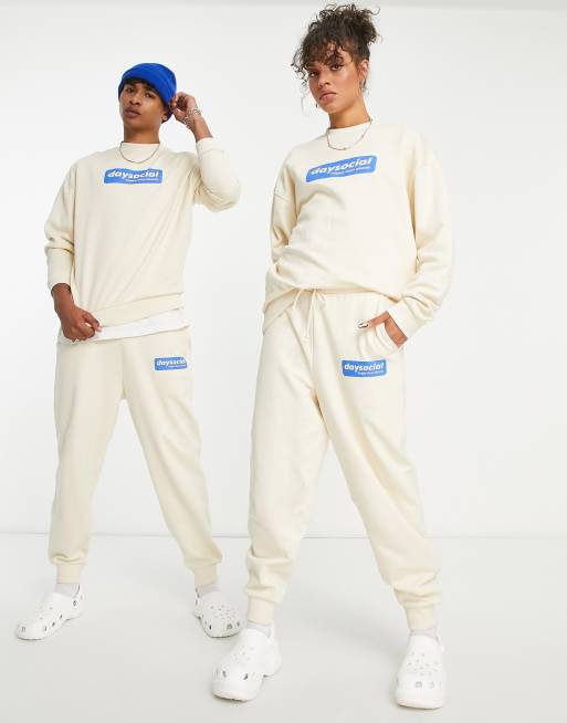 ASOS Daysocial unisex relaxed sweatpants with blue badge logo print in ecru - part of a set