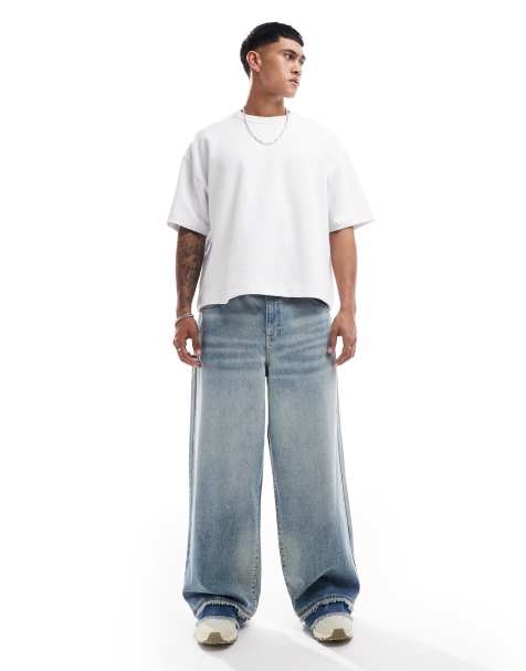 ASOS DEESIGN – Superweite Jeans in hellblauer Vintage-Waschung mit Farbstich und ausgefranstem Saum - view 1