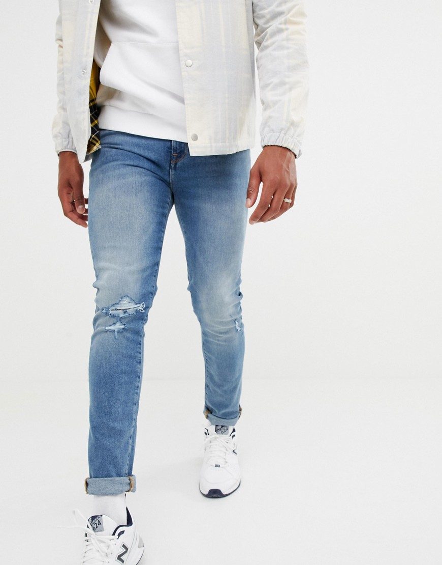 ASOS Design - 12.5oz skinny jeans in lichte vintage wassing met gescheurde knie-Blauw