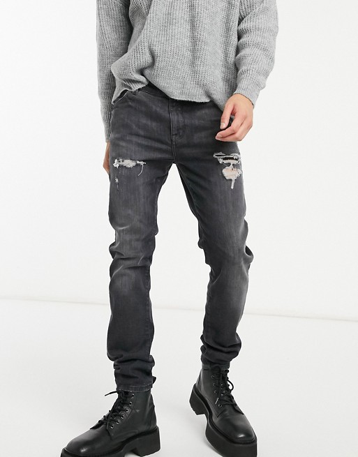 ASOS DESIGN 12.5oz skinny jeans in vintage washed black with abrasions