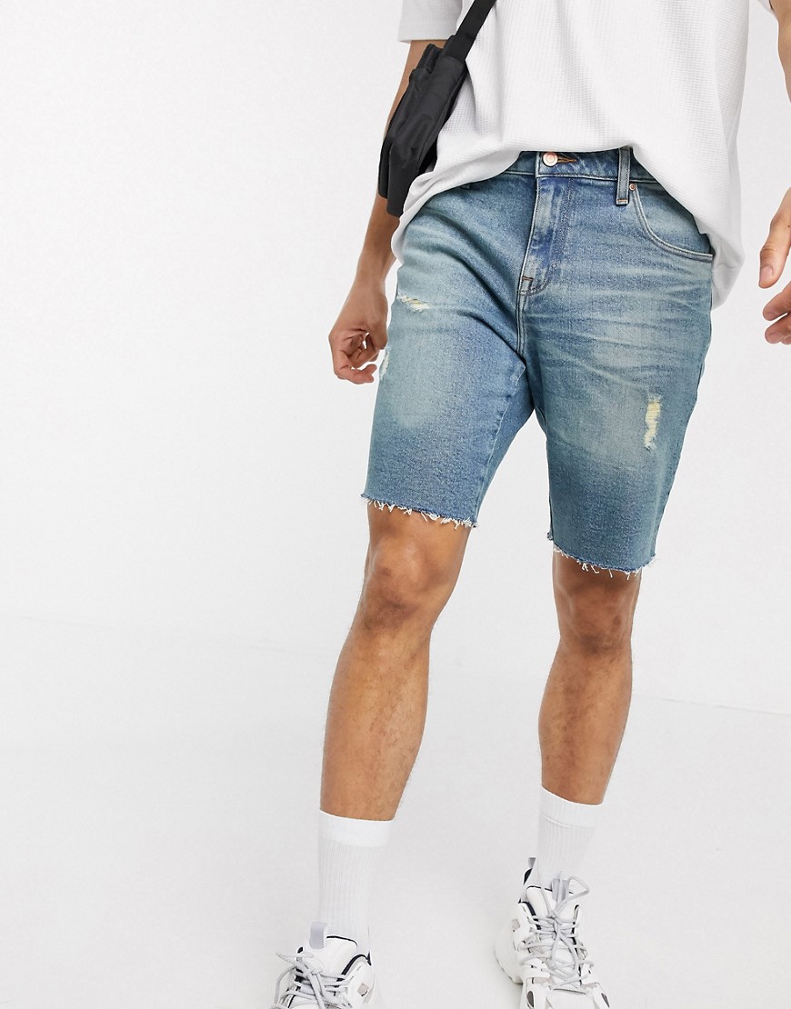 ASOS DESIGN 12.5oz slim denim shorts in dark wash blue with abrasions and raw hem