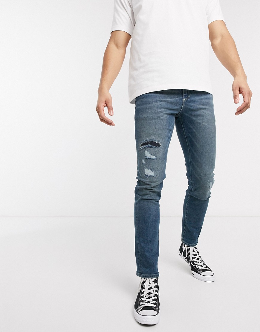 ASOS DESIGN 12.5oz slim jeans in vintage mid wash blue with rip and repair