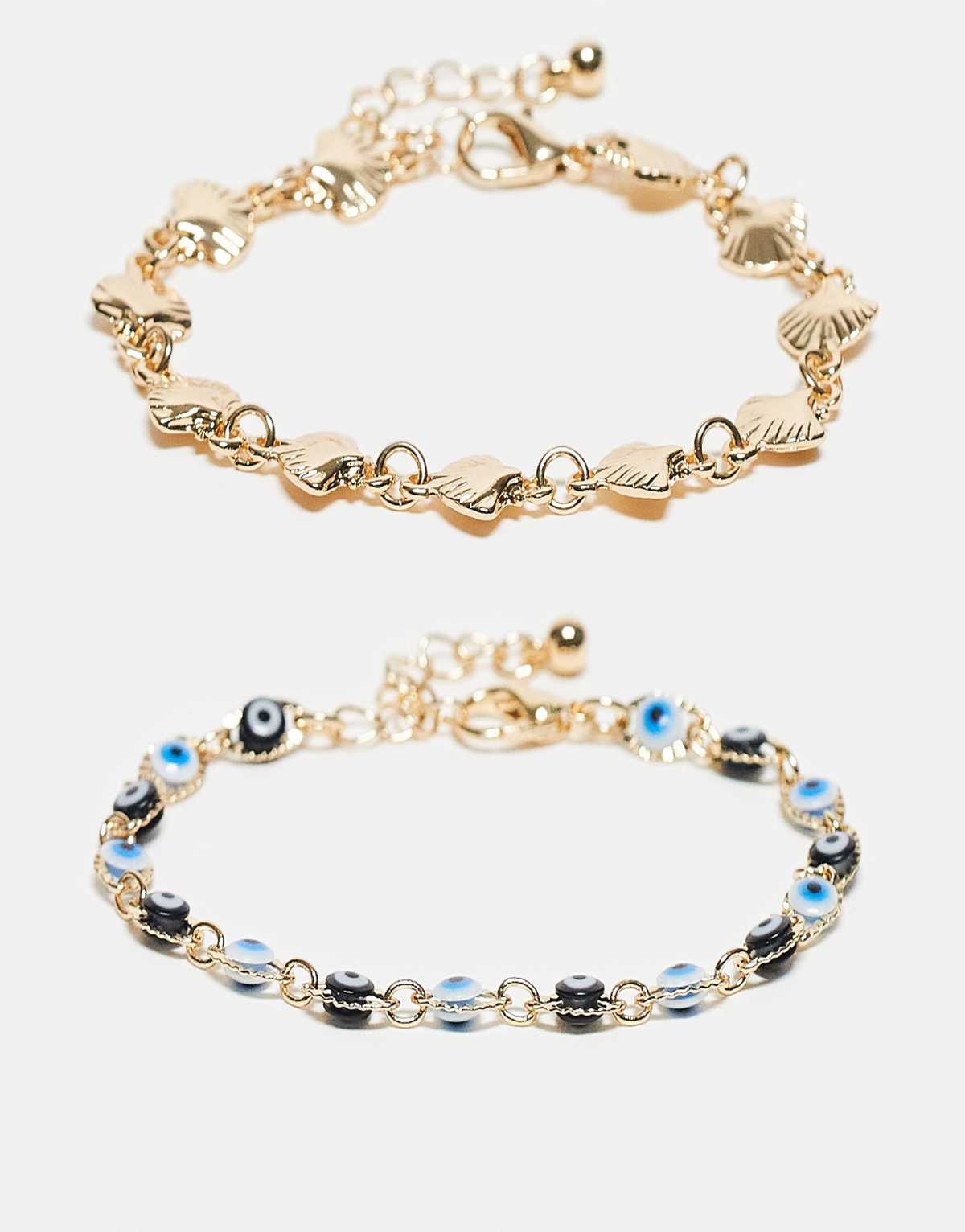ASOS DESIGN 2 pack of bracelets with faux shell and eye design in gold tone