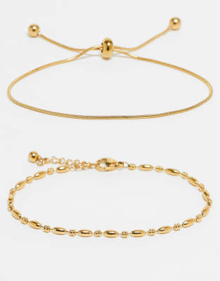 ASOS DESIGN - 2er-Pack feingliedrige Freundschafts-Armbänder aus wasserfestem Edelstahl mit Geschenkbeutel-Goldfarben