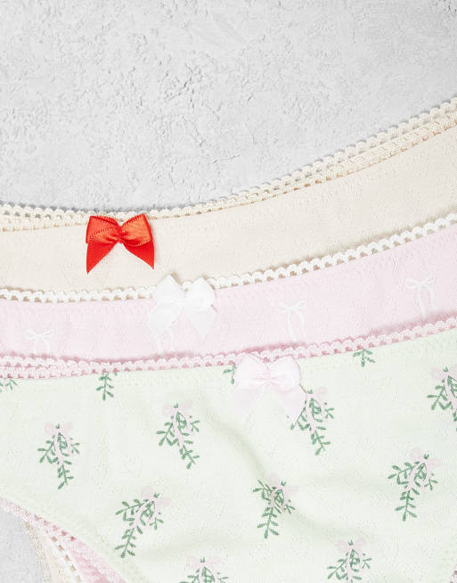 ASOS DESIGN 3 pack christmas heart pointelle thong pack with mistletoe and bow print in green, cream & pink, 2 of 3