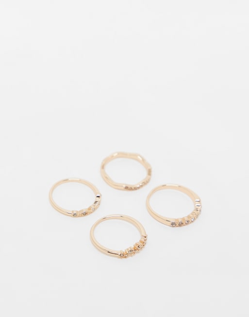 ASOS DESIGN – 4er-Set goldfarbene Ringe mit zarten Kristalldetails