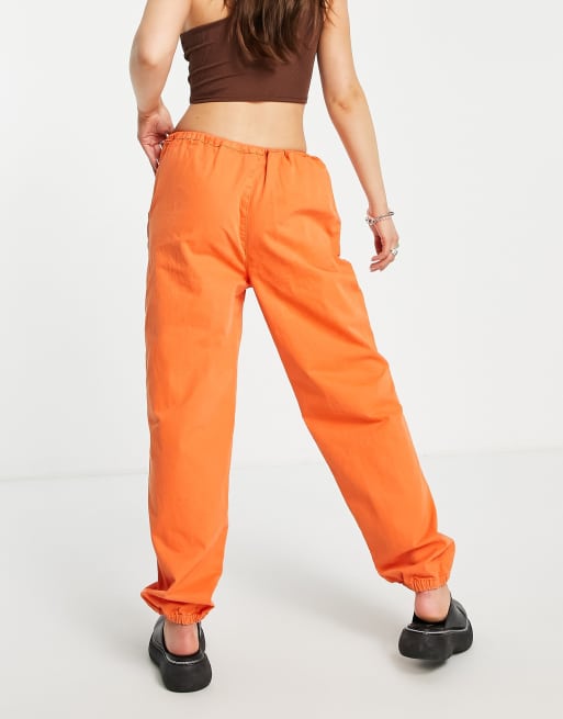 ASOS DESIGN 90s cargo pants with toggle detail in bright orange