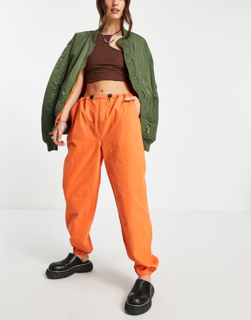 ASOS DESIGN 90s cargo pants with toggle detail in bright orange