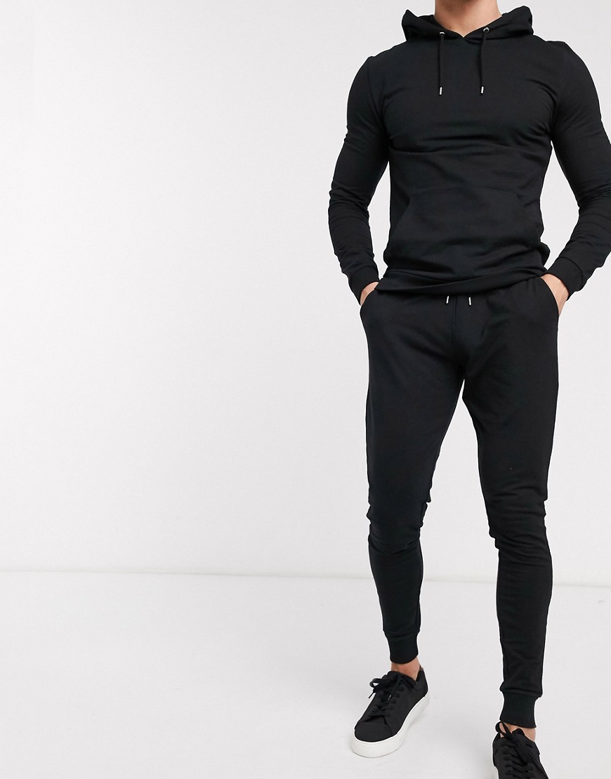 ASOS DESIGN - Aansluitend trainingspak met hoodie & extreem superskinny joggingbroek in zwart