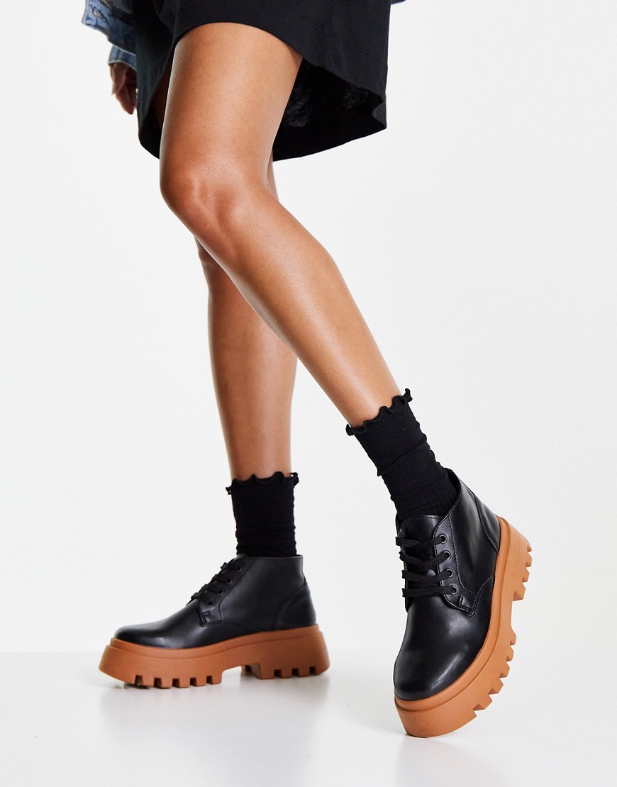 ASOS DESIGN Abuzz lace up boots in black with tan sole