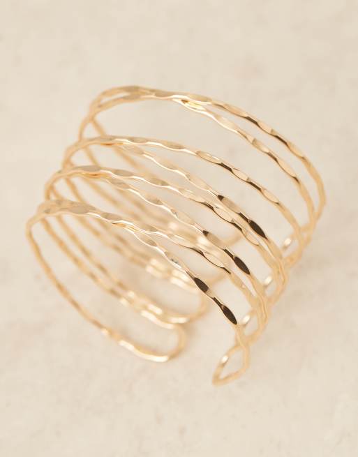 ASOS DESIGN arm cuff with hammered wraparound design in gold tone