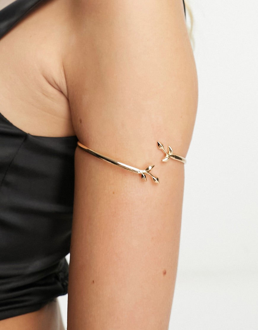ASOS DESIGN arm cuff with wraparound leaf design in gold tone