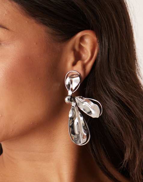 ASOS DESIGN asymetric stud earrings with textured metal half-flower design in silver tone - view 1