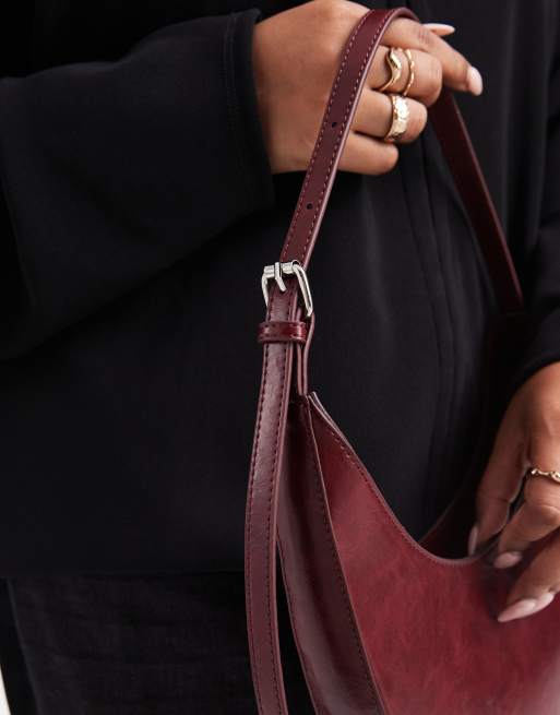 ASOS DESIGN asymmetric scoop shoulder bag with buckle detail in washed burgundy