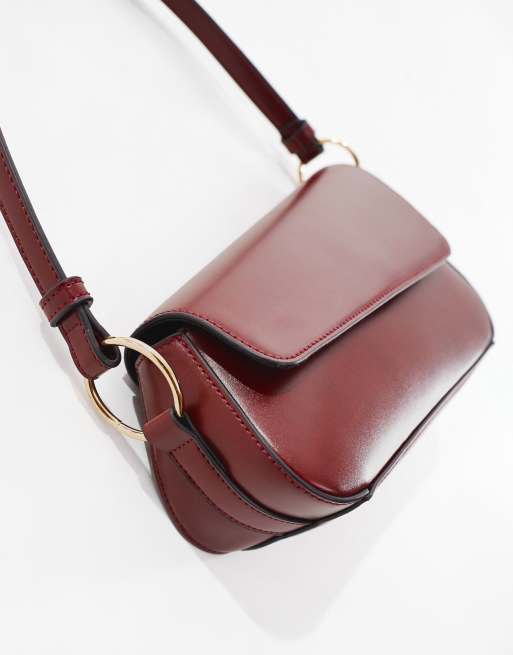 ASOS DESIGN asymmetric shoulder bag with front flap in burgundy