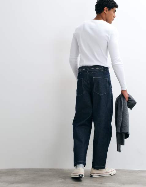 ASOS DESIGN – Avsmalnande jeans i otvättad denim med avslappnad passform, veck och spänne - view 1
