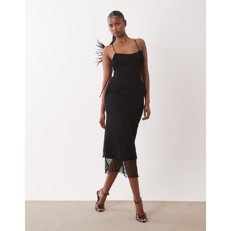 ASOS DESIGN awkward length dobby mesh slip dress with ruched bust and peek  a boo hem detail in black | ASOS