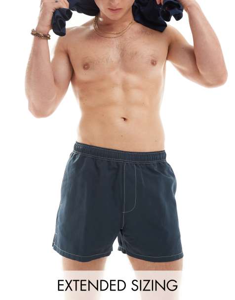 ASOS DESIGN – Badeshorts in Marineblau mit kürzerer Länge und kontrastierenden Ziernähten - view 1