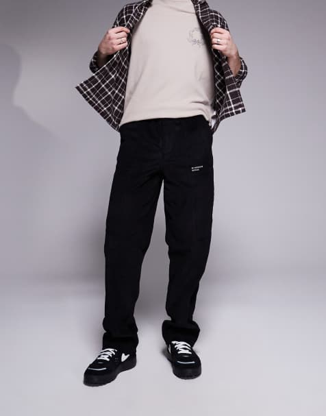 ASOS DESIGN baggy cord trousers with embroidered patch in black - view 1