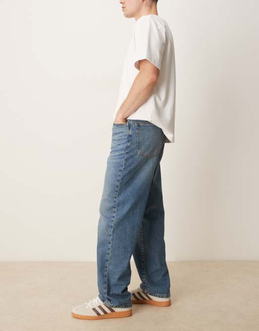 ASOS DESIGN baggy fit jeans in mid wash blue