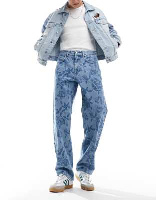 ASOS DESIGN baggy jean in mid wash with all over floral print-Blue