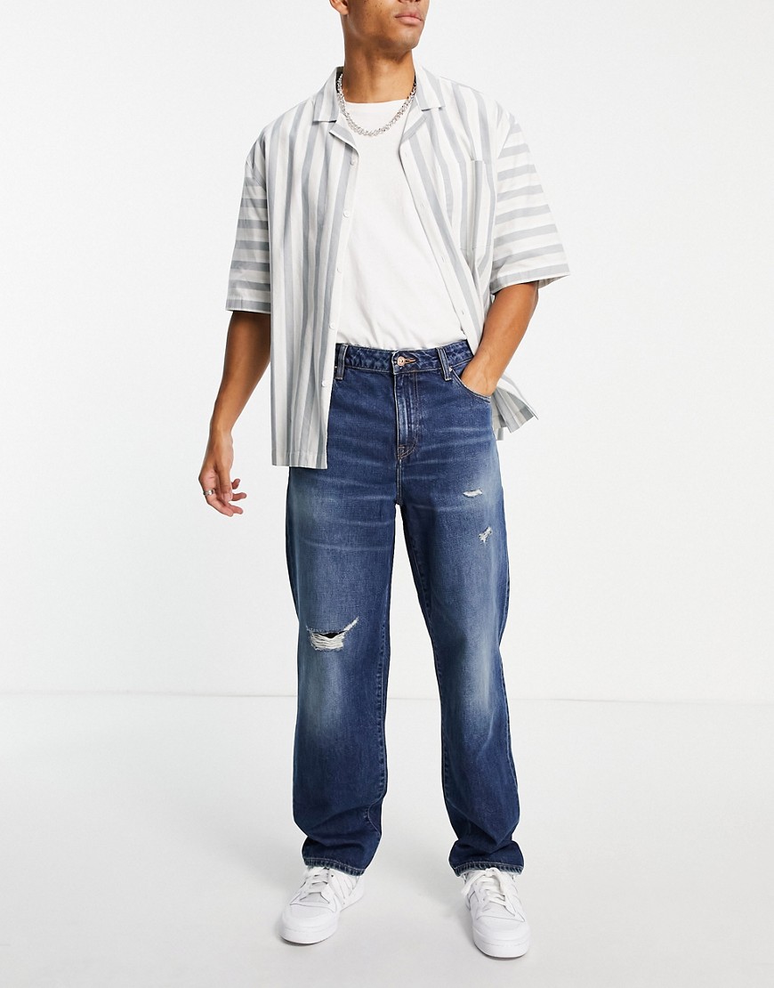 ASOS DESIGN baggy jeans in dark wash with abrasions-Blues