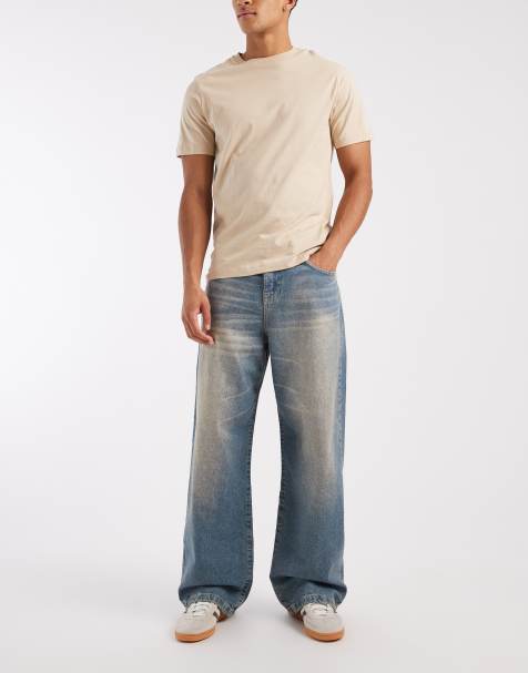 ASOS DESIGN – Baggy-Jeans in verwaschenem Dunkelblau mit gelbem Farbstich und Bindegürtel in der Taille - view 1