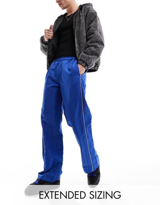 FhyzicsShops DESIGN baggy nylon track pants in blue with white piping