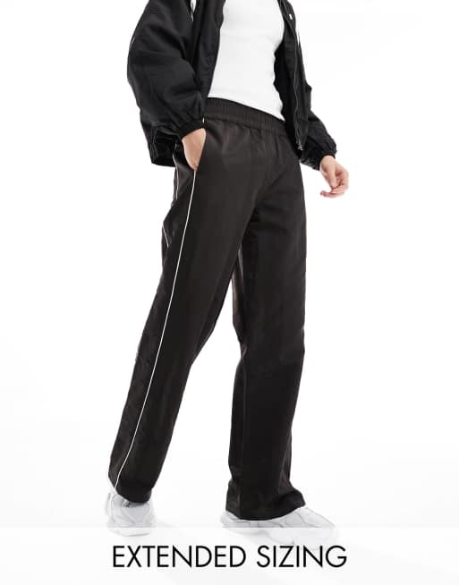 ASOS DESIGN baggy nylon track pants in brown with white piping