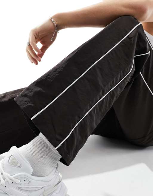 ASOS DESIGN baggy nylon track pants in brown with white piping | ASOS