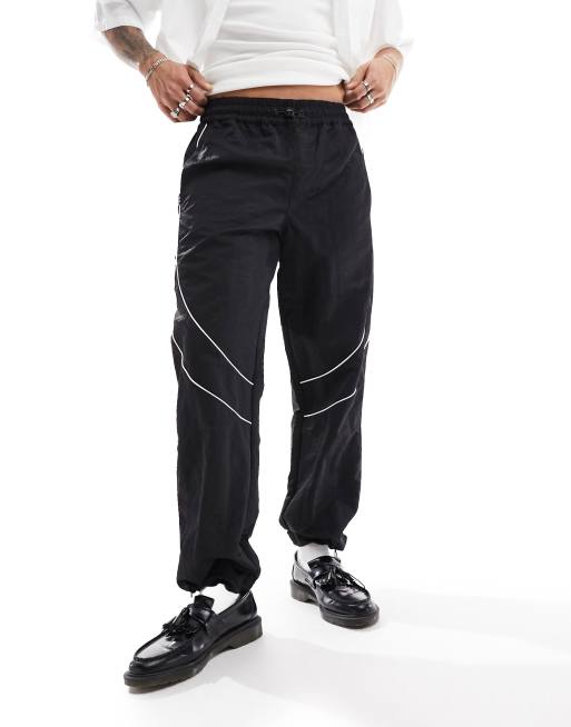 ASOS DESIGN baggy nylon track pants with contrast piping in black