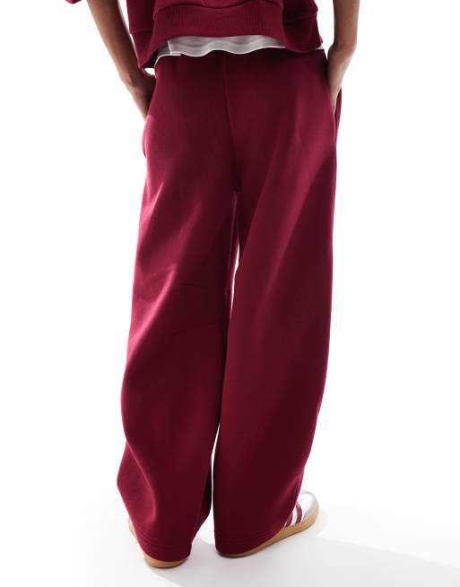 ASOS DESIGN barrel leg trackies in burgundy