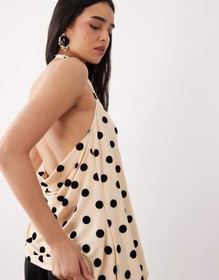 ASOS DESIGN - Beflocktes Longline-Oberteil aus Netzstoff in Schwarz-Weiß mit Neckholder und asymmetrischem Saum-Bunt