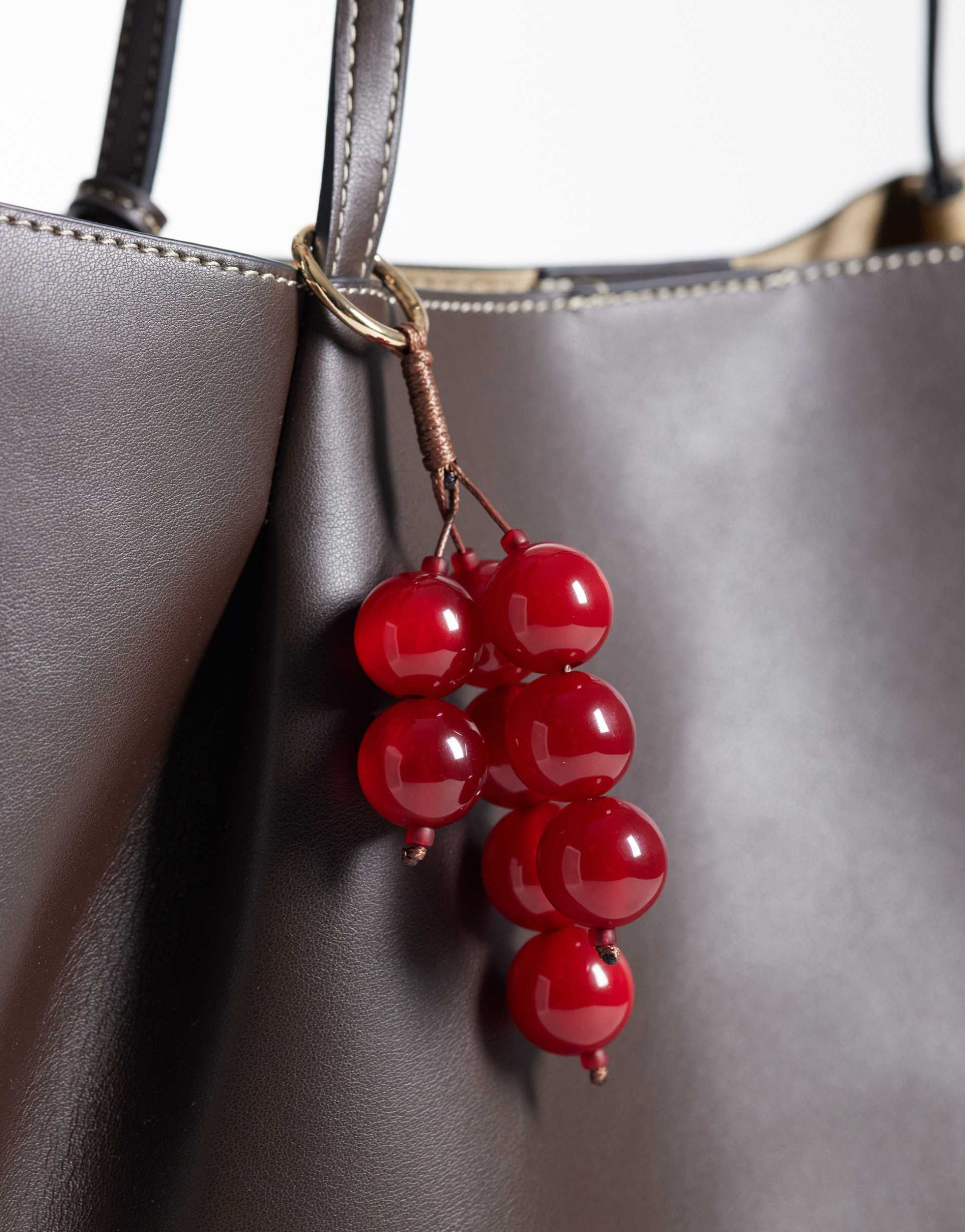 asos design berry bag charm in red