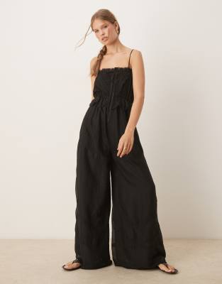 ASOS DESIGN – Bestickter Jumpsuit in Schwarz mit schmalen Trägern und Banddetails - view 1